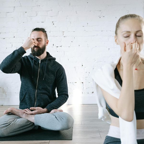 Person meditating peacefully in a bright, airy room.
